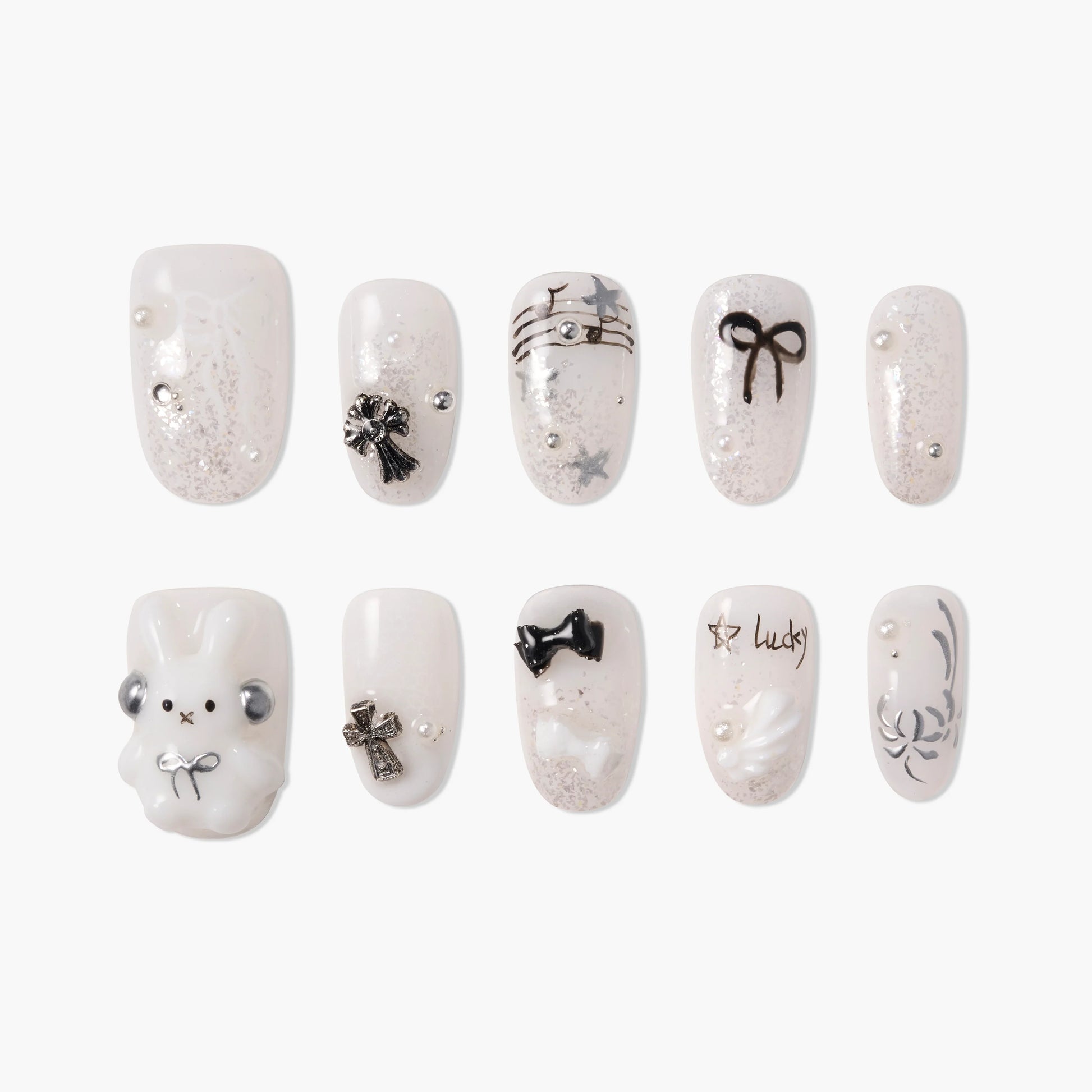 Cute white and silver press-on nails with black bows, stars, pearls, and 3D bunny design.