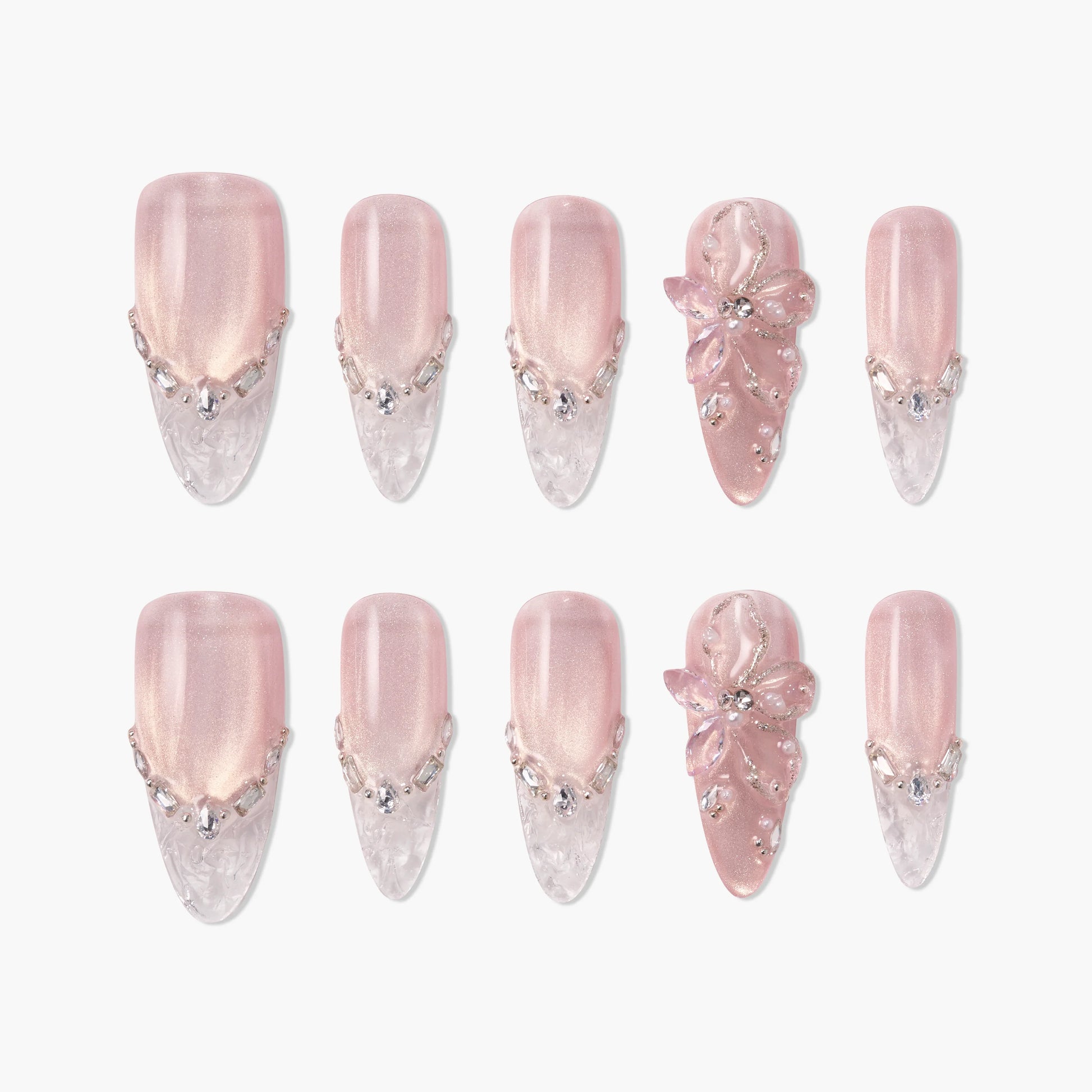 Pink and clear press-on nails with 3D floral accents and rhinestone embellishments