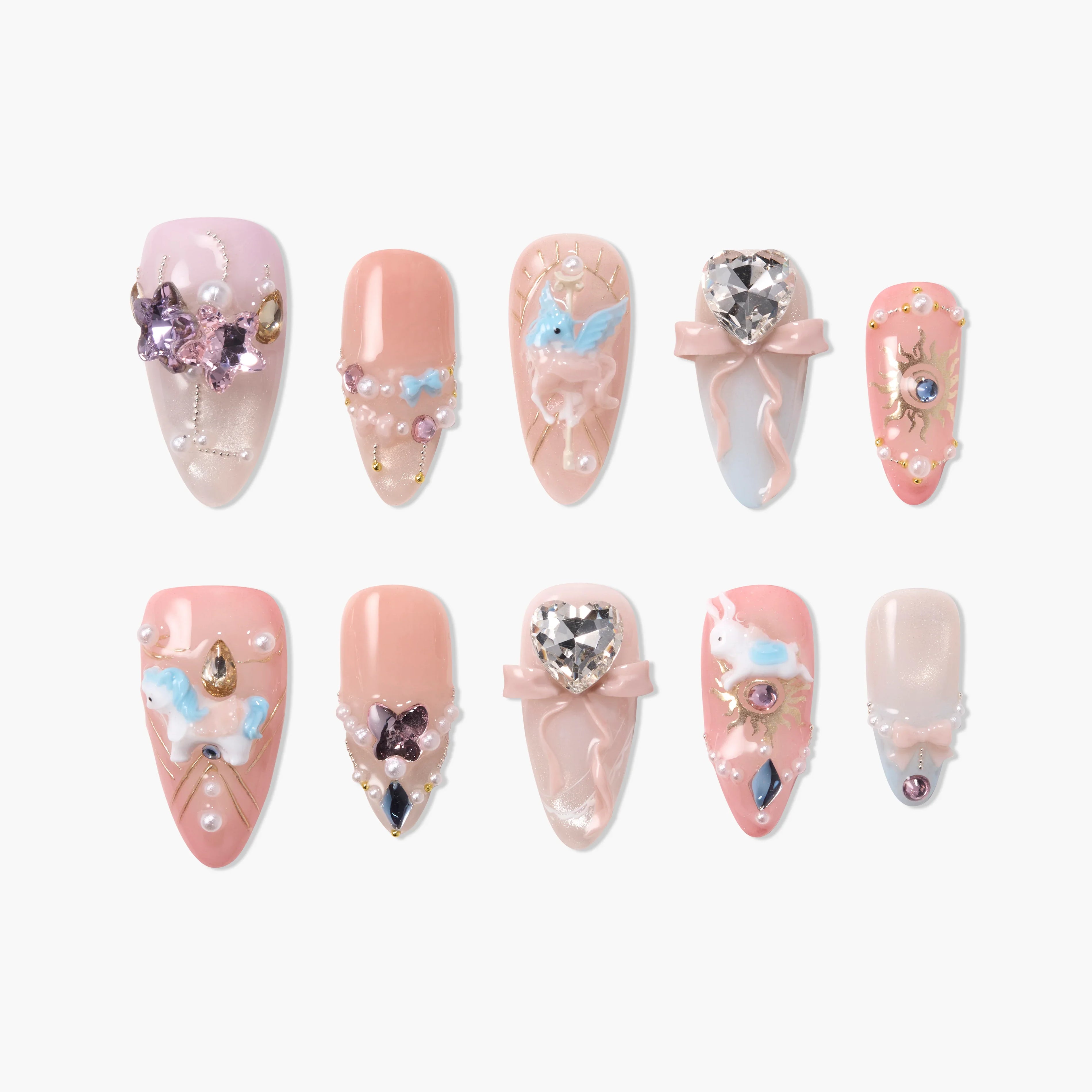 Handmade press-on nails in pink hues with 3D gems, pearls, and unicorn nail art accents.