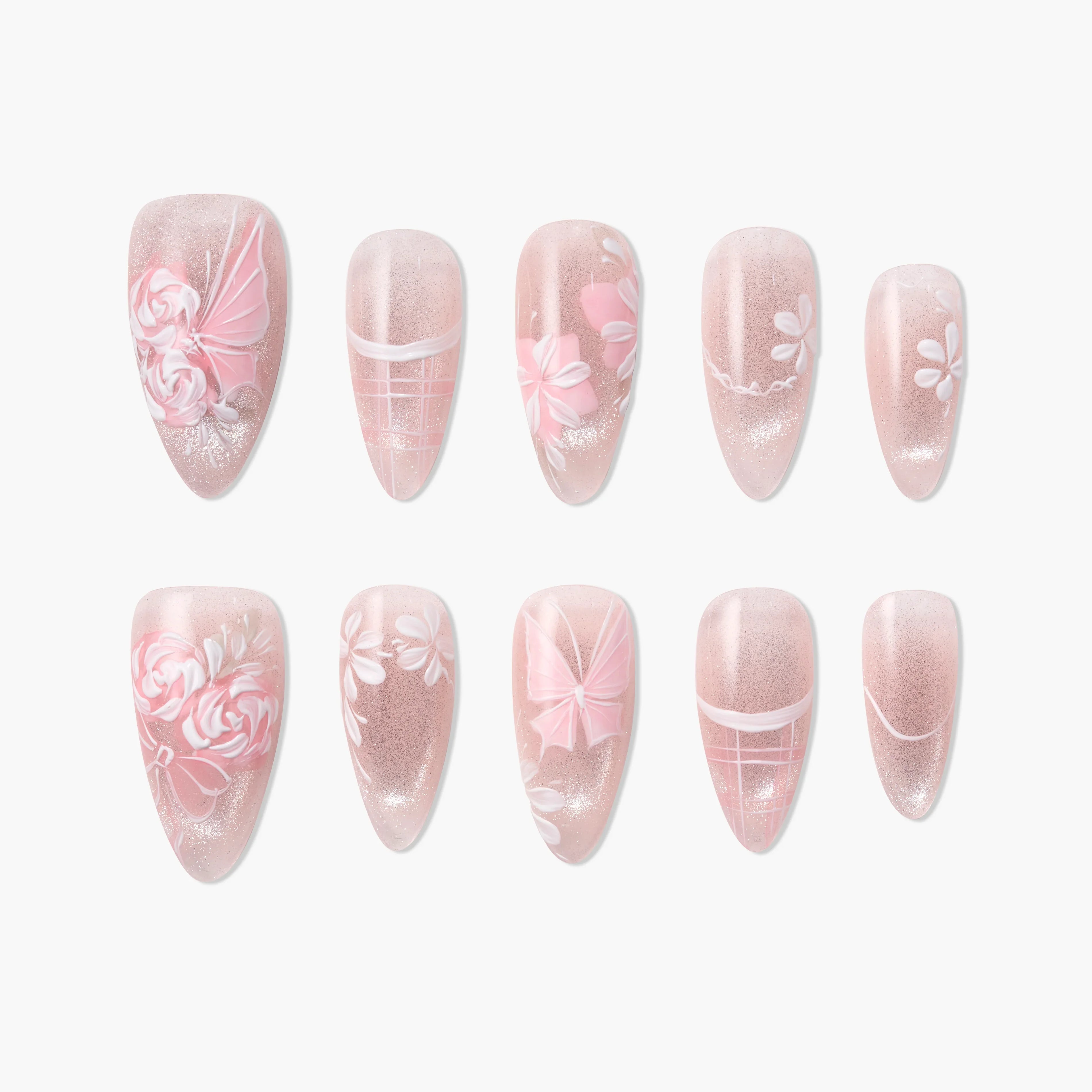 Handmade press-on nails with pink floral and bow designs on a glittery nude background