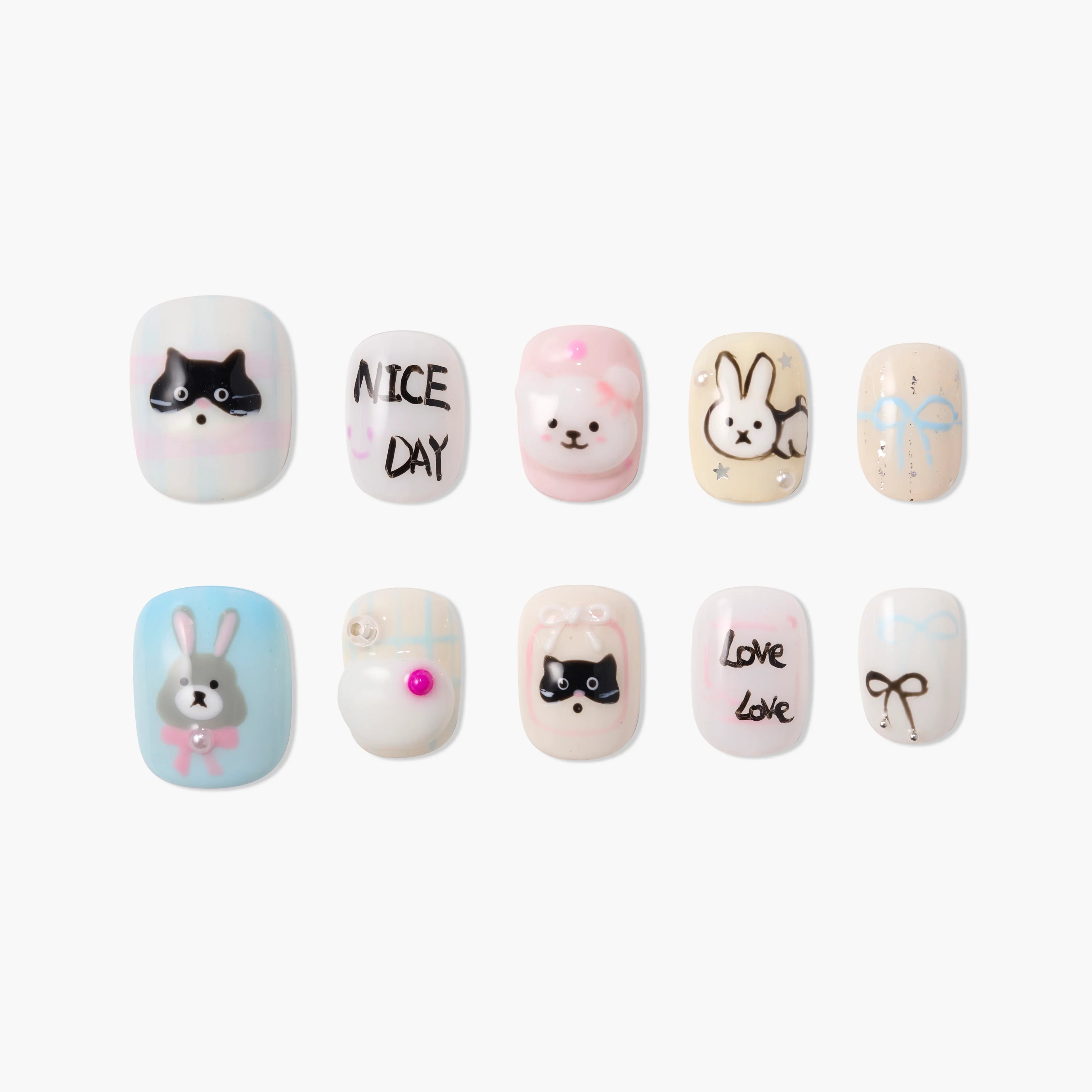 Cute animal and bow design press-on nails with pastel colors and playful text accents.