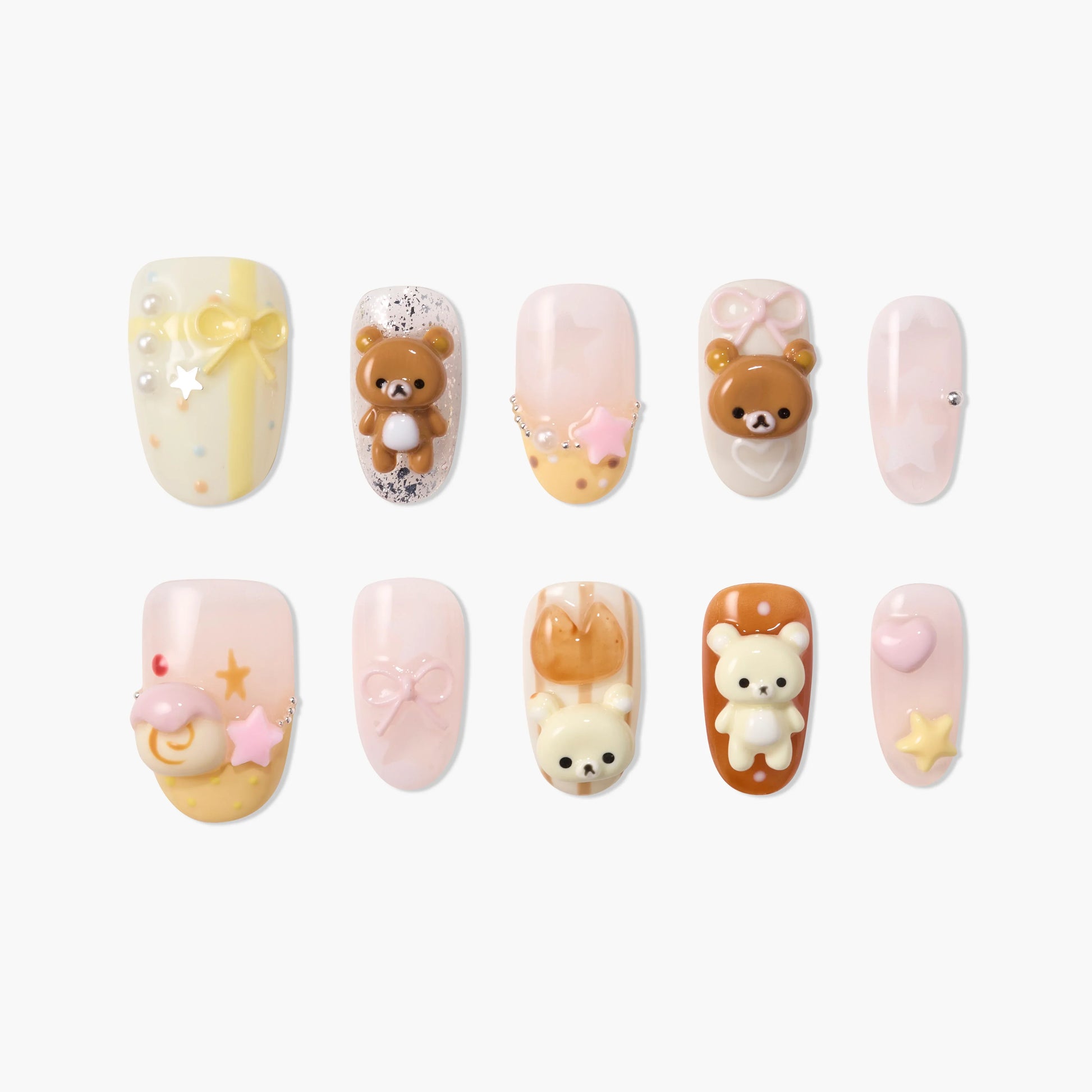 Handmade press-on nails with kawaii 3D bear, bow, and star designs in pastel colors