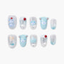 Handmade press-on nails with blue and silver bear and cherry designs, glitter accents