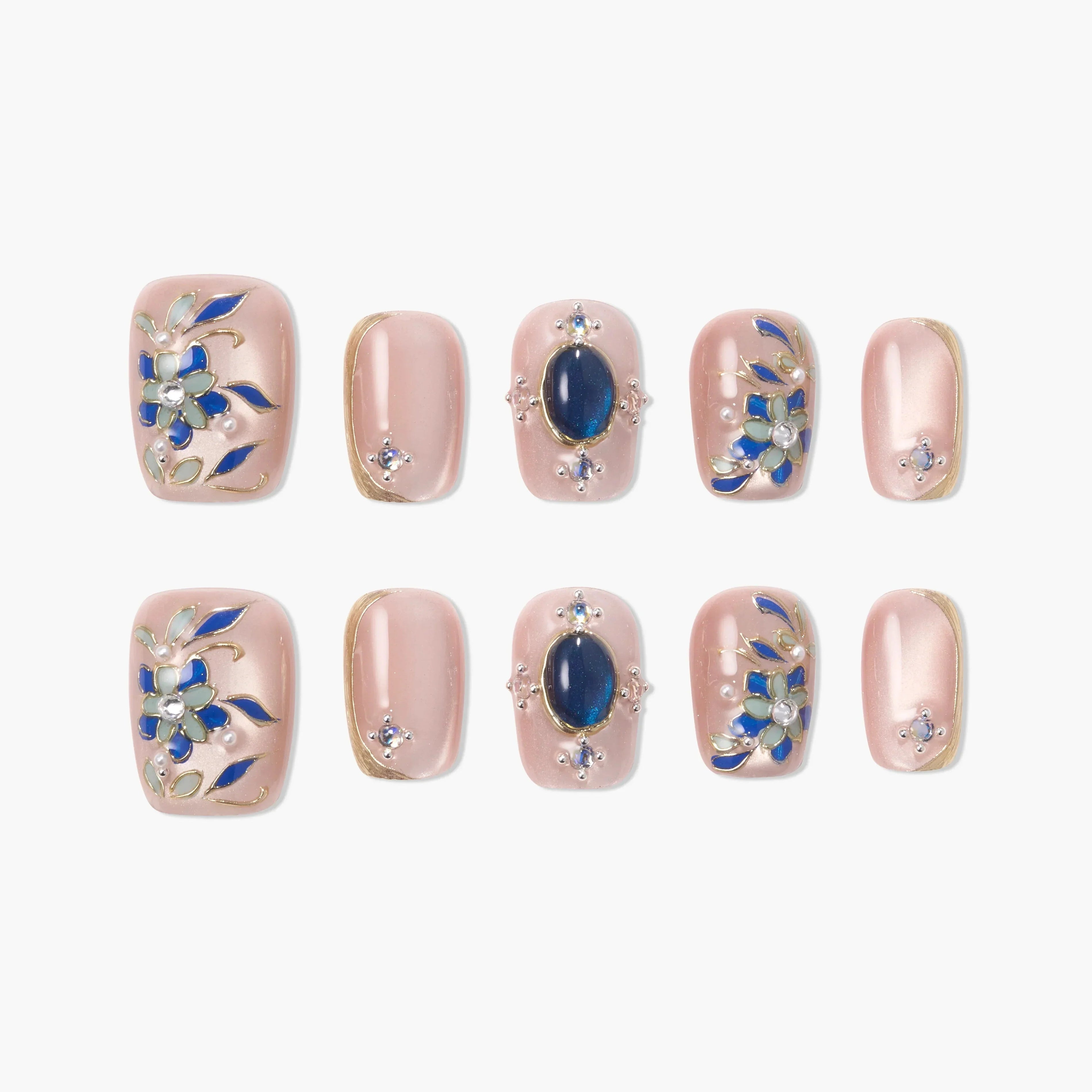 Pink handmade press-on nails with blue floral designs and gemstone accents, set of ten.