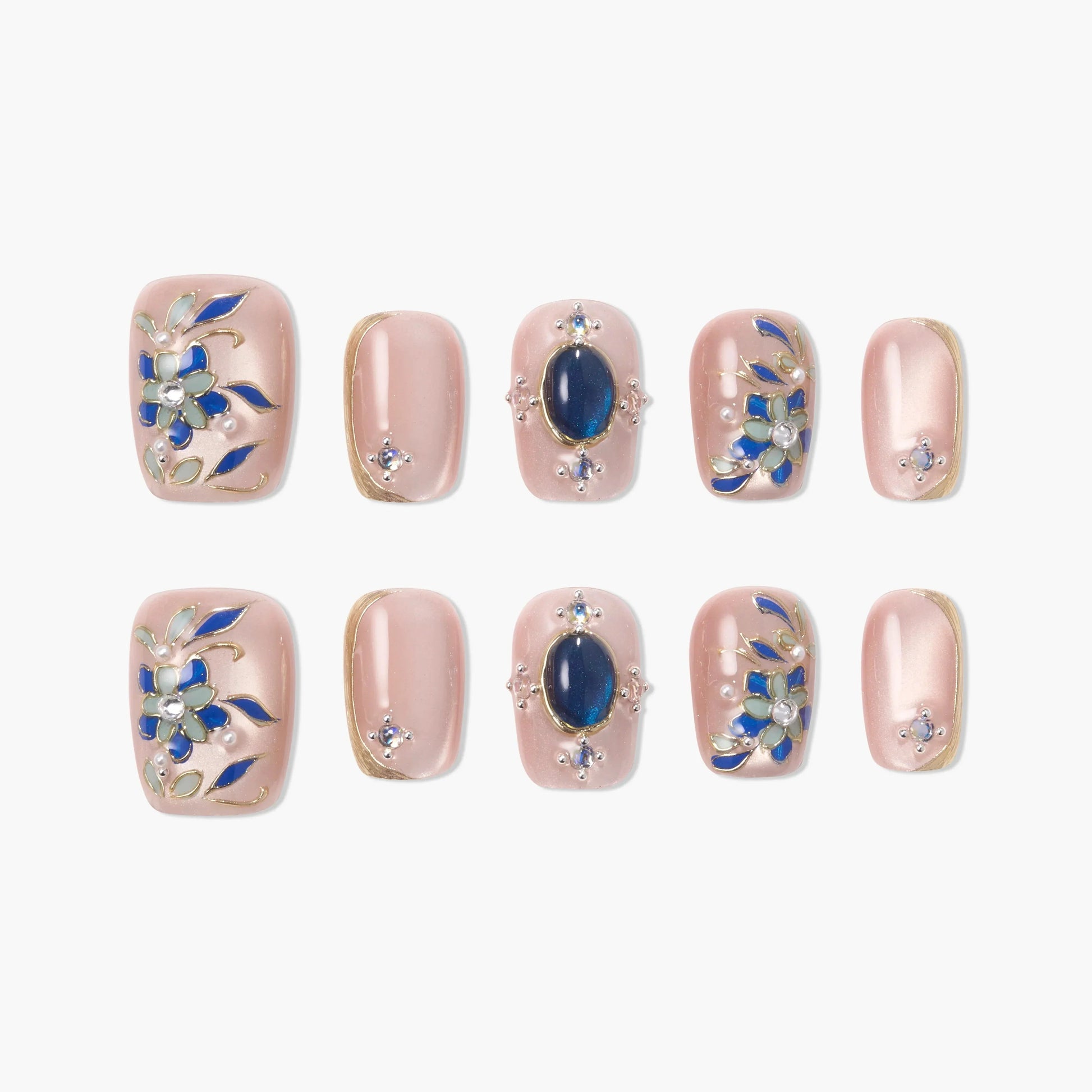 Pink handmade press-on nails with blue floral designs and gemstone accents, set of ten.