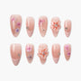 Handmade press-on nails with nude base, floral designs, 3D flowers, and rhinestone accents