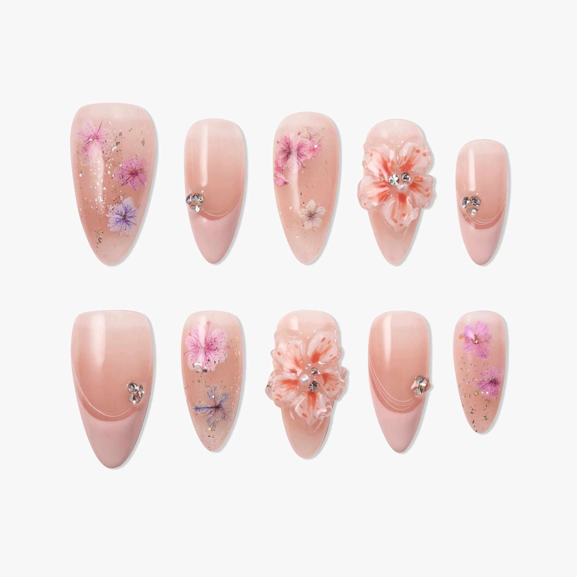 Handmade press-on nails with nude base, floral designs, 3D flowers, and rhinestone accents