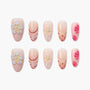 Handmade press-on nails with pink floral, polka dot, and pearl accent designs