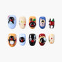 Handmade press-on nails with colorful cartoon designs, penguins, apples, and playful art