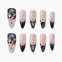 Handmade press-on nails with pink glitter, black tips, floral roses, bows, and pearl accents.