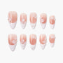 Handmade pink and white press-on nails with 3D floral and pearl design, arranged on white background