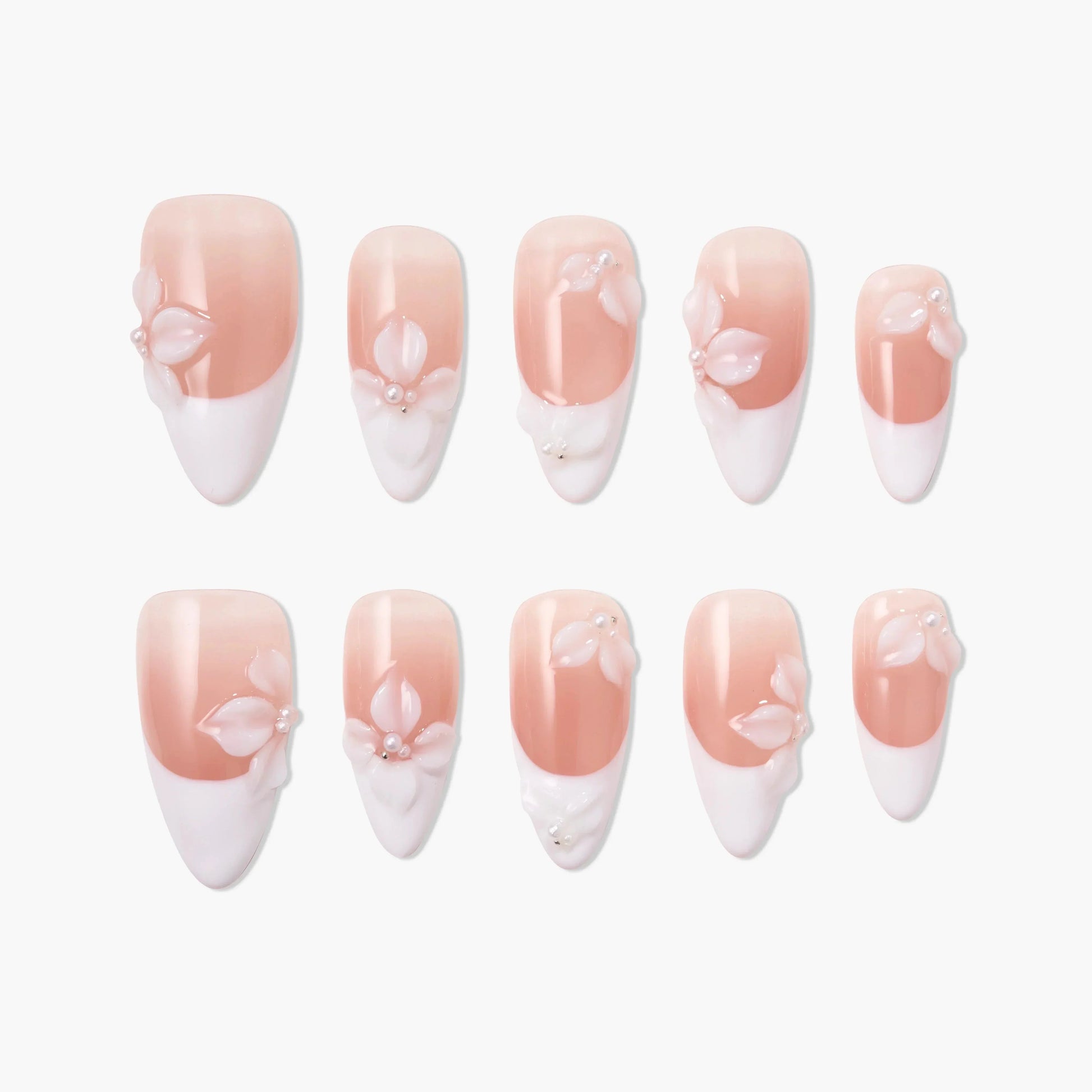 Handmade pink and white press-on nails with 3D floral and pearl design, arranged on white background