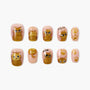 Handmade press-on nails with gold glitter cat designs and paw prints on nude background