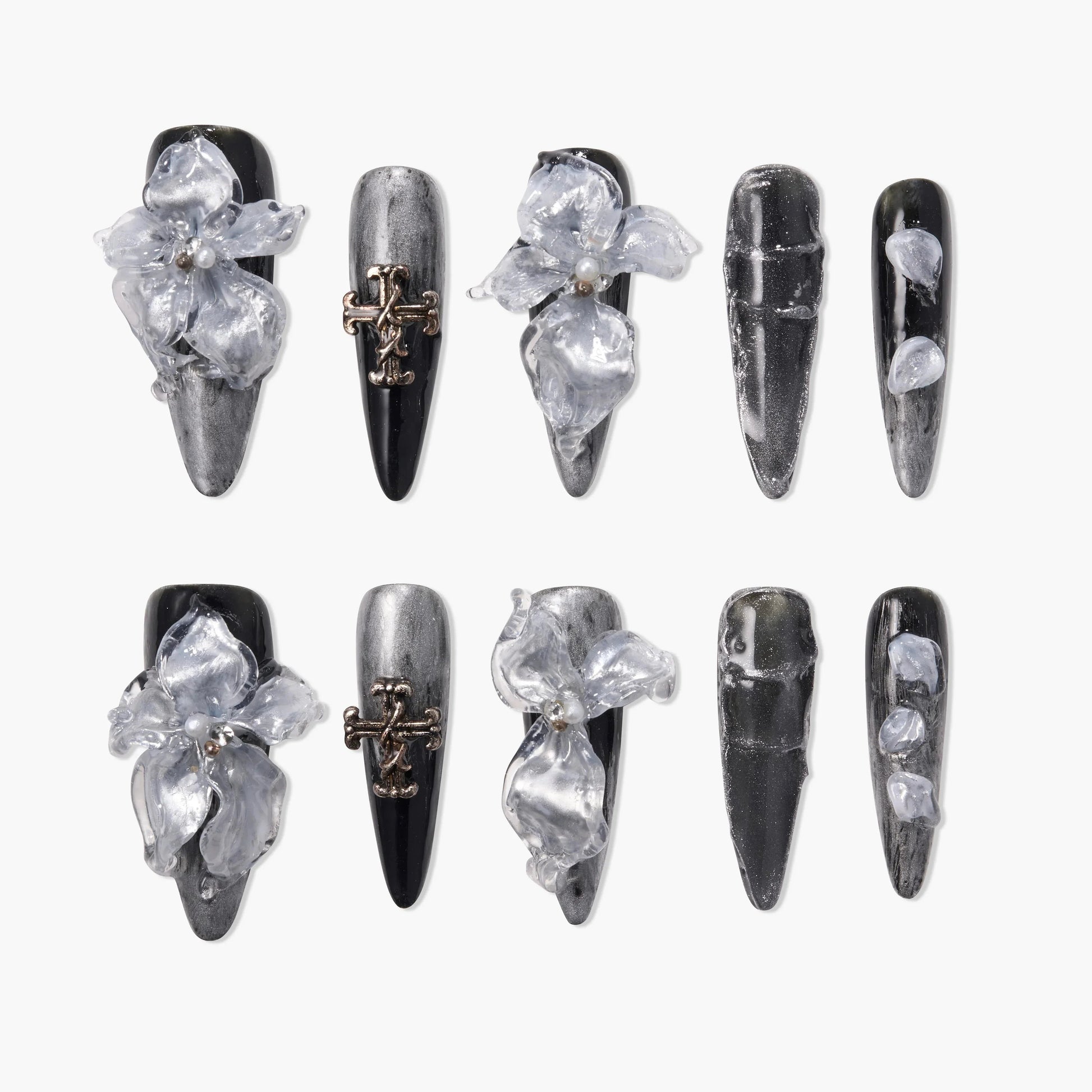Black and silver press-on nails with 3D clear floral accents and metallic cross charms