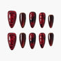 Handmade press-on nails with glossy wine red marble and rose designs, gold accents, and 3D details