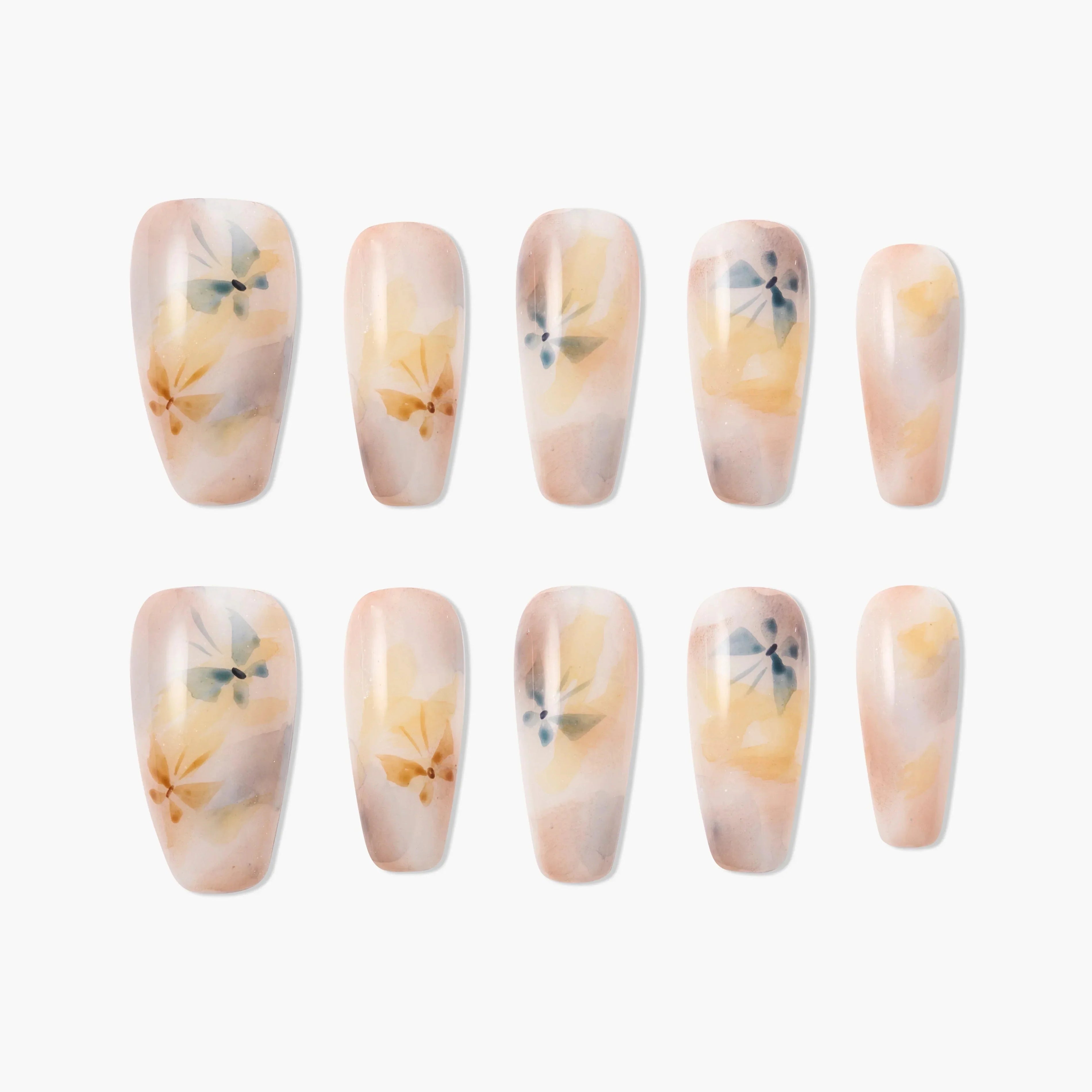 Handmade press-on nails with watercolor floral design in soft peach and yellow tones