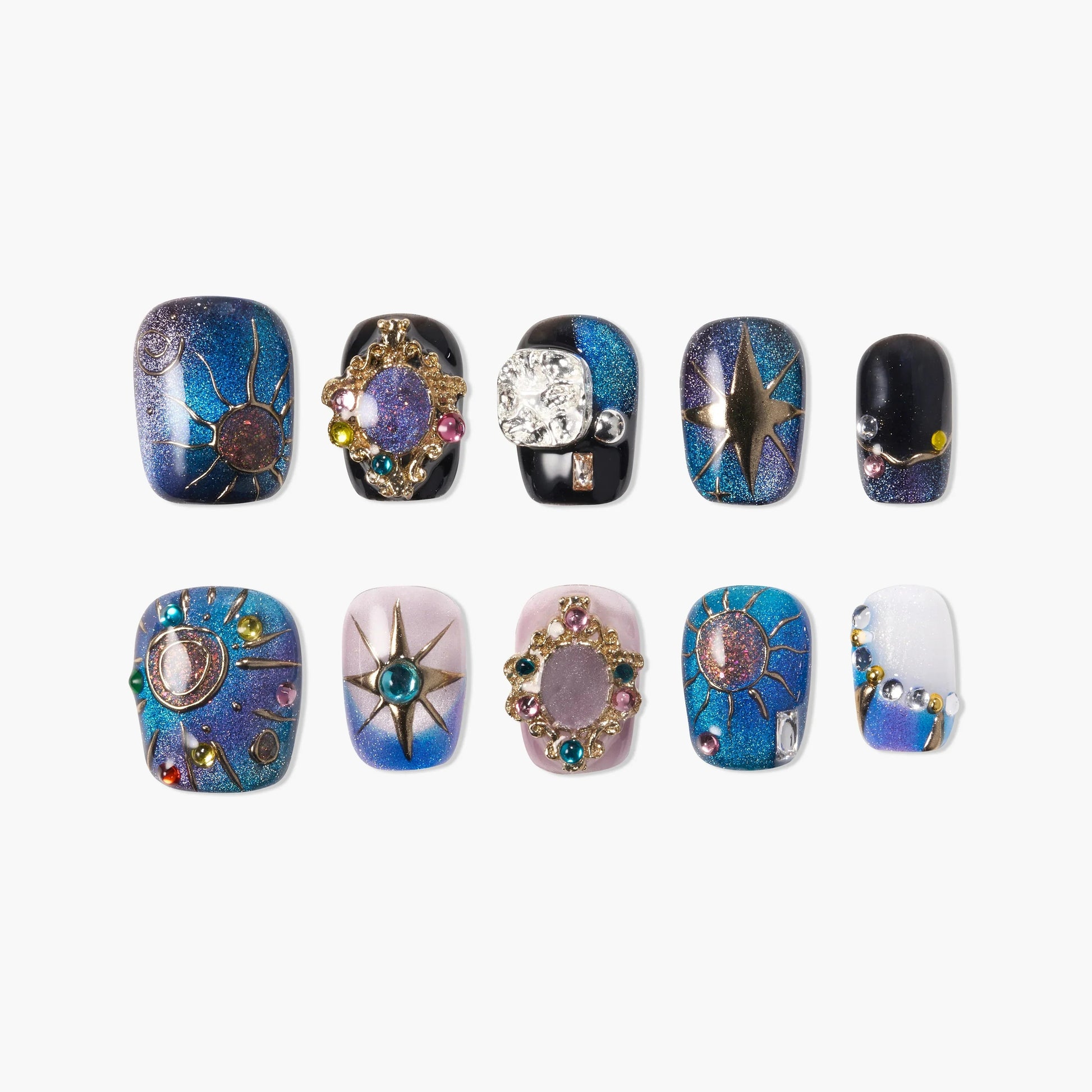 Celestial-themed press-on nails with blue glitter, gold sun and star designs, and colorful gems