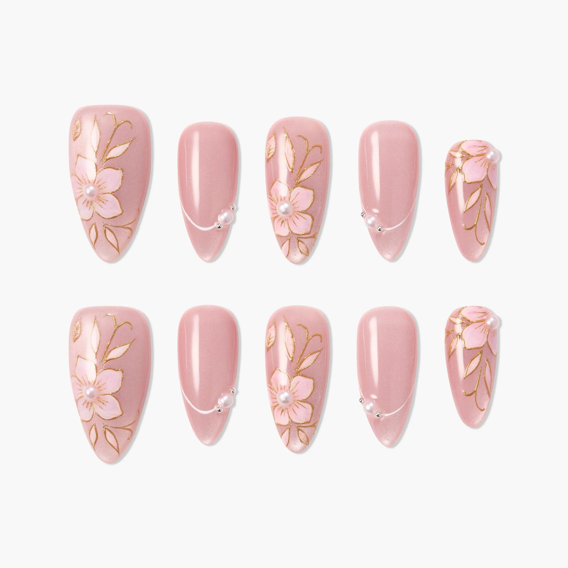 Pink press-on nails with floral designs, gold accents, and pearl embellishments.