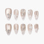 Pearl nude press-on nails with 3D crystals, floral accents, and intricate rhinestone designs