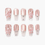 Handmade press-on nails in pink with 3D floral designs, pearls, and rhinestone accents