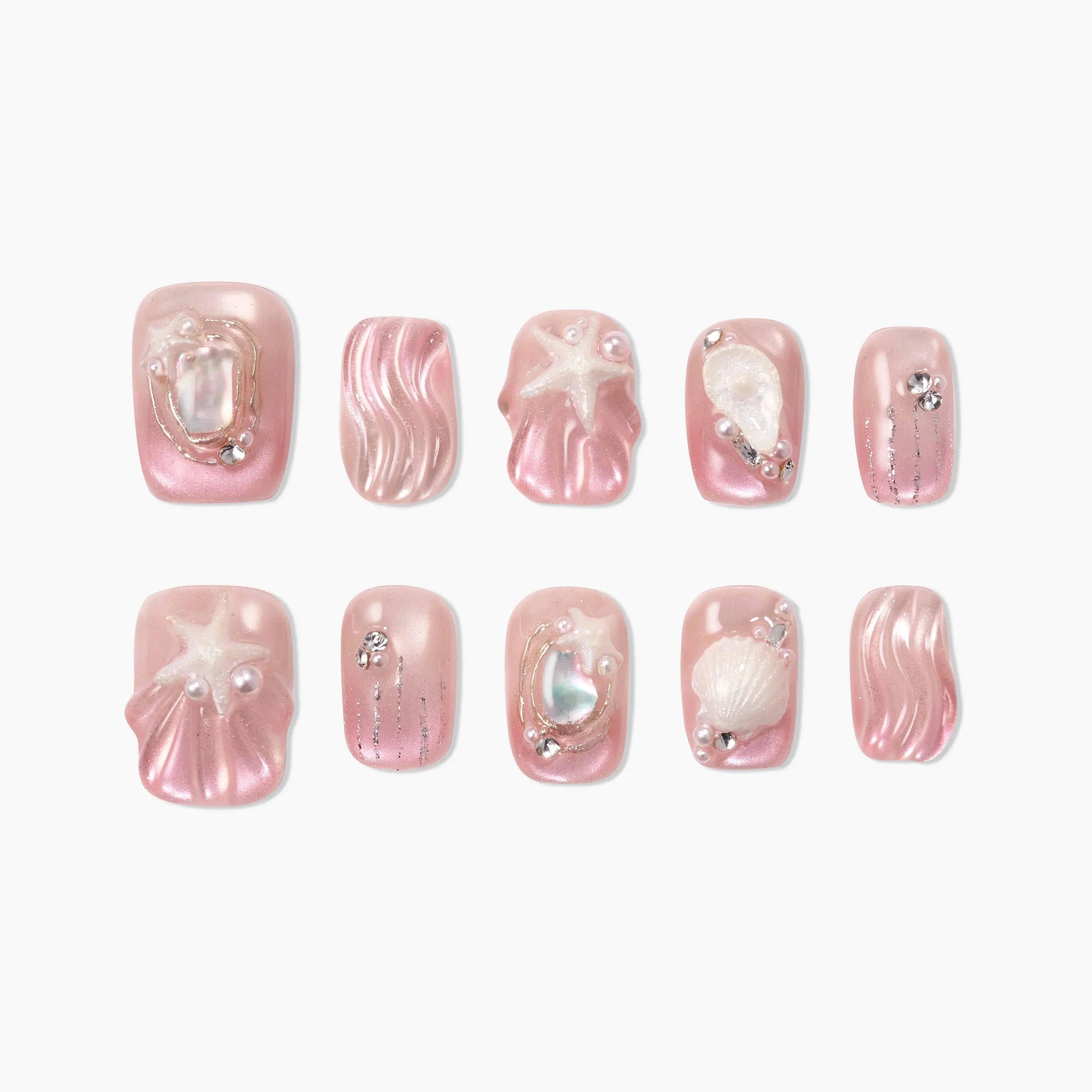 Set of pink press-on nails with pearl, seashell, starfish, and rhinestone accents