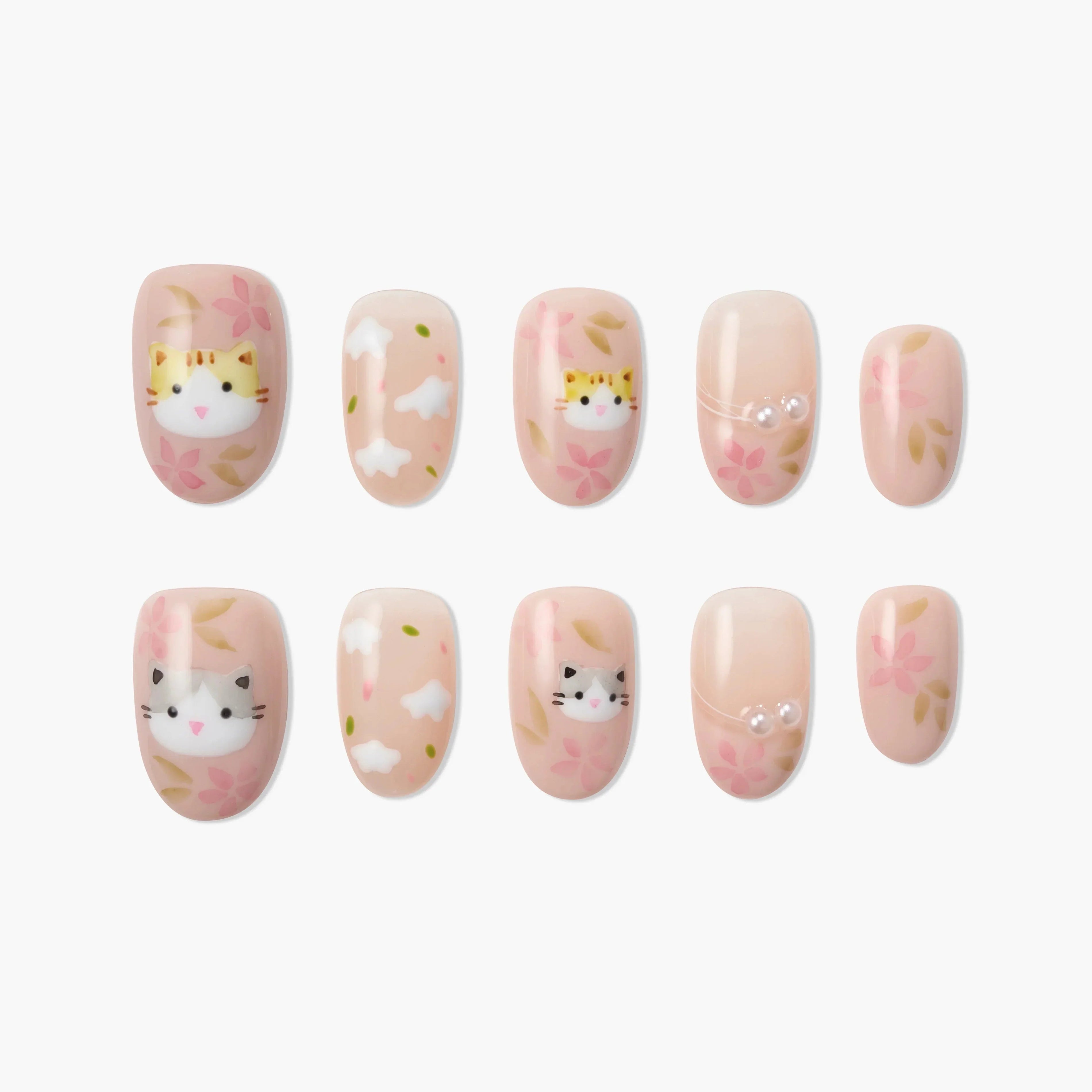 Handmade press-on nails with cat faces, floral designs, and pink nude base, kawaii style