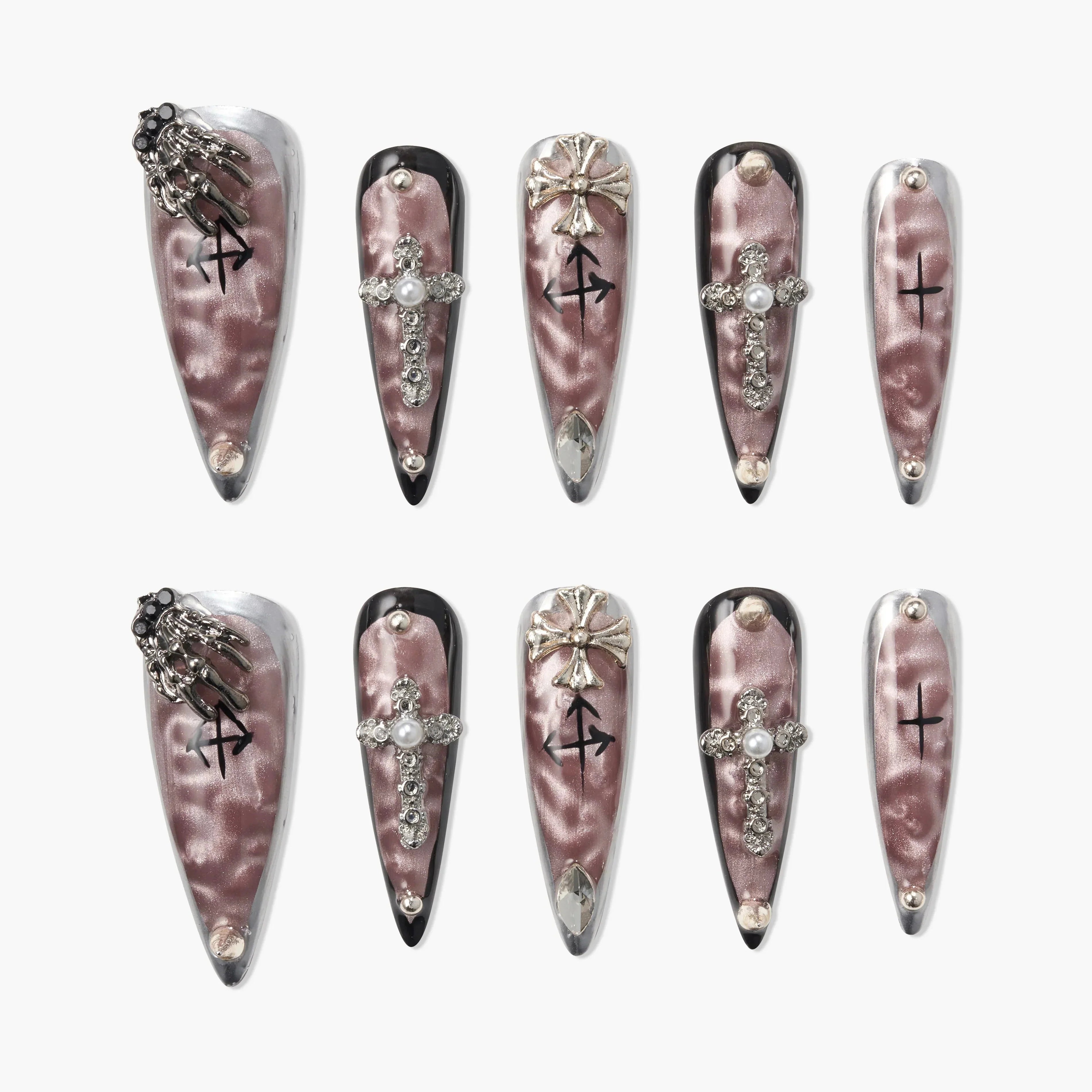 Long coffin-shaped press-on nails with metallic pink finish, jeweled cross, gothic details, and silver accents