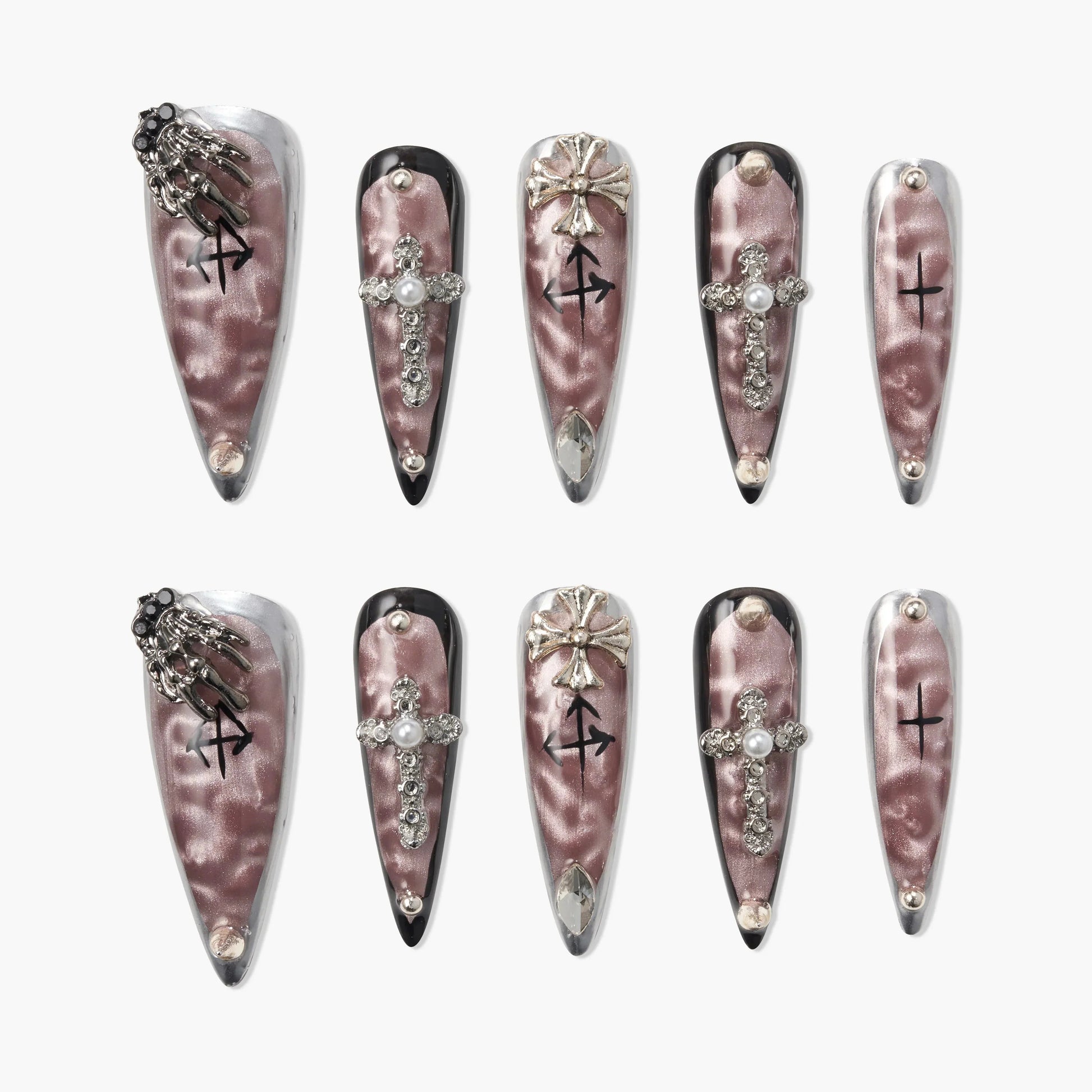 Long coffin-shaped press-on nails with metallic pink finish, jeweled cross, gothic details, and silver accents