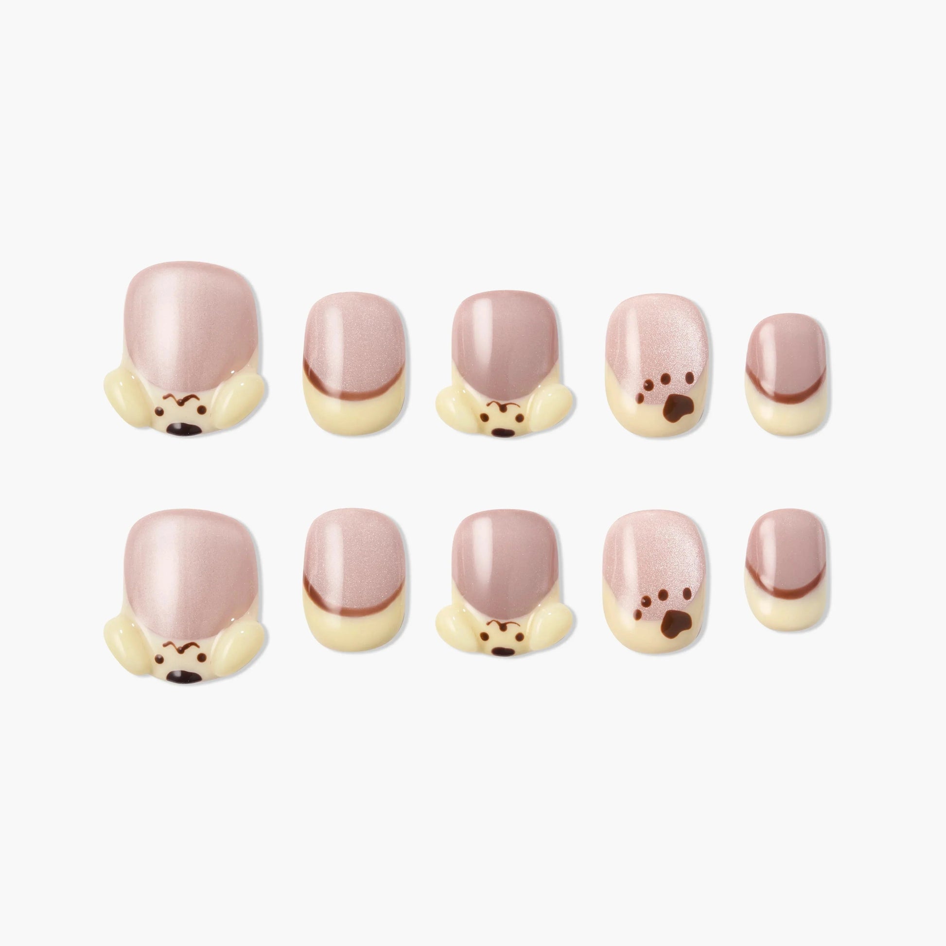 Cute animal-themed pink and beige press-on nails with paw and face designs, arranged on white background.