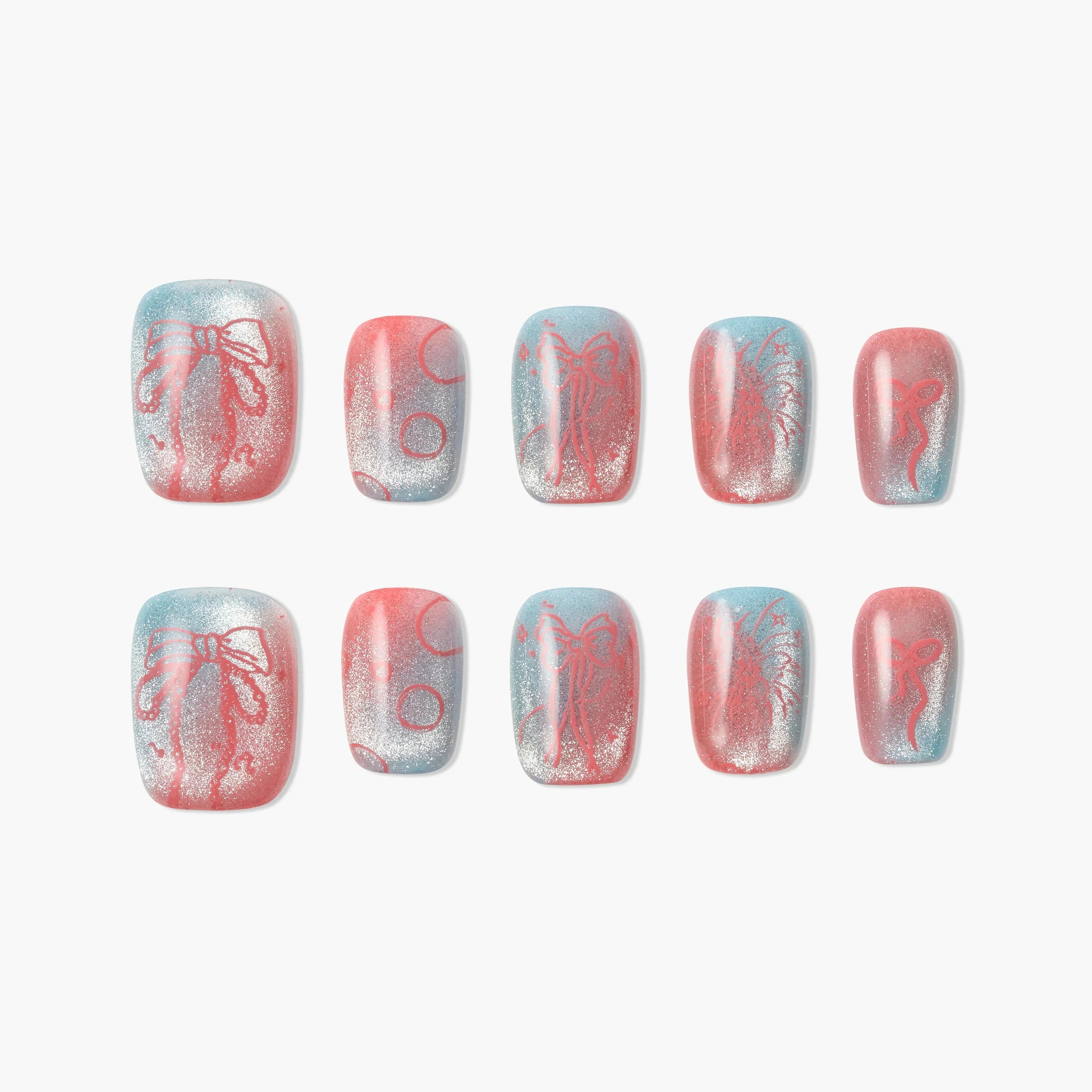 Handmade press-on nails with pink, blue, and silver glitter, featuring bow and polka dot designs