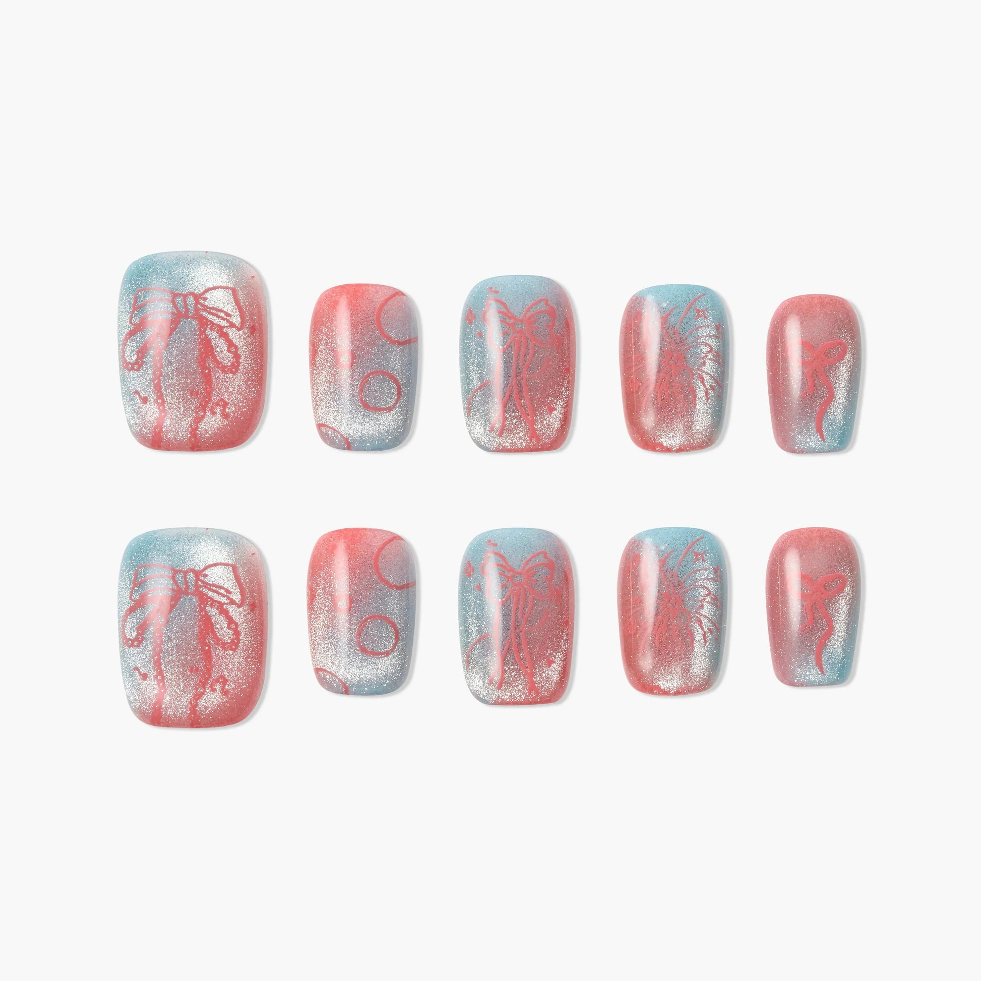 Handmade press-on nails with pink, blue, and silver glitter, featuring bow and polka dot designs
