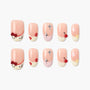 Cute pink press-on nails with cartoon faces, stars, cherries, flowers, and glitter accents