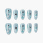 Blue glitter press-on nails with black and silver star designs, set of ten on white background