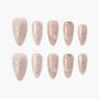 Blush pink press-on nails with silver bows, rhinestones, and pearl accents, elegant design.