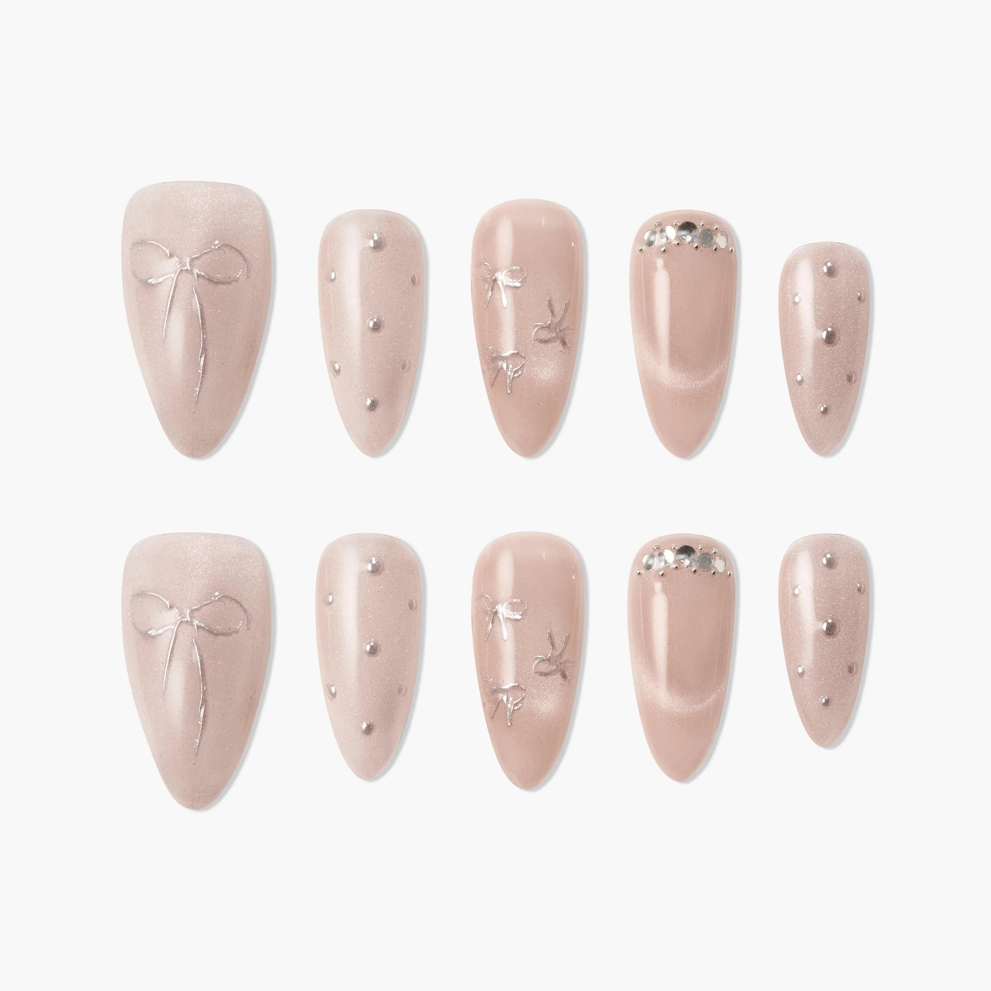 Blush pink press-on nails with silver bows, rhinestones, and pearl accents, elegant design.