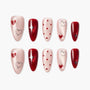 Handmade press-on nails set with red and pink heart, polka dot, and star designs