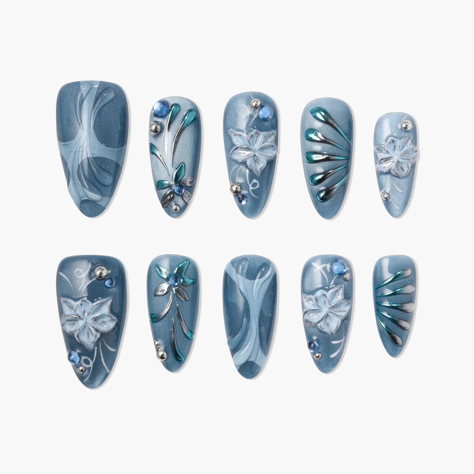 Handmade blue press-on nails with 3D floral designs, silver accents, and rhinestones on white background