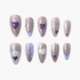 Handmade press-on nails with shimmer lilac base, 3D heart and moon decorations, pearl accents, reusable design.