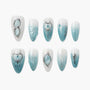 Blue and white ombre press-on nails with metallic silver 3D accents and gemstone details