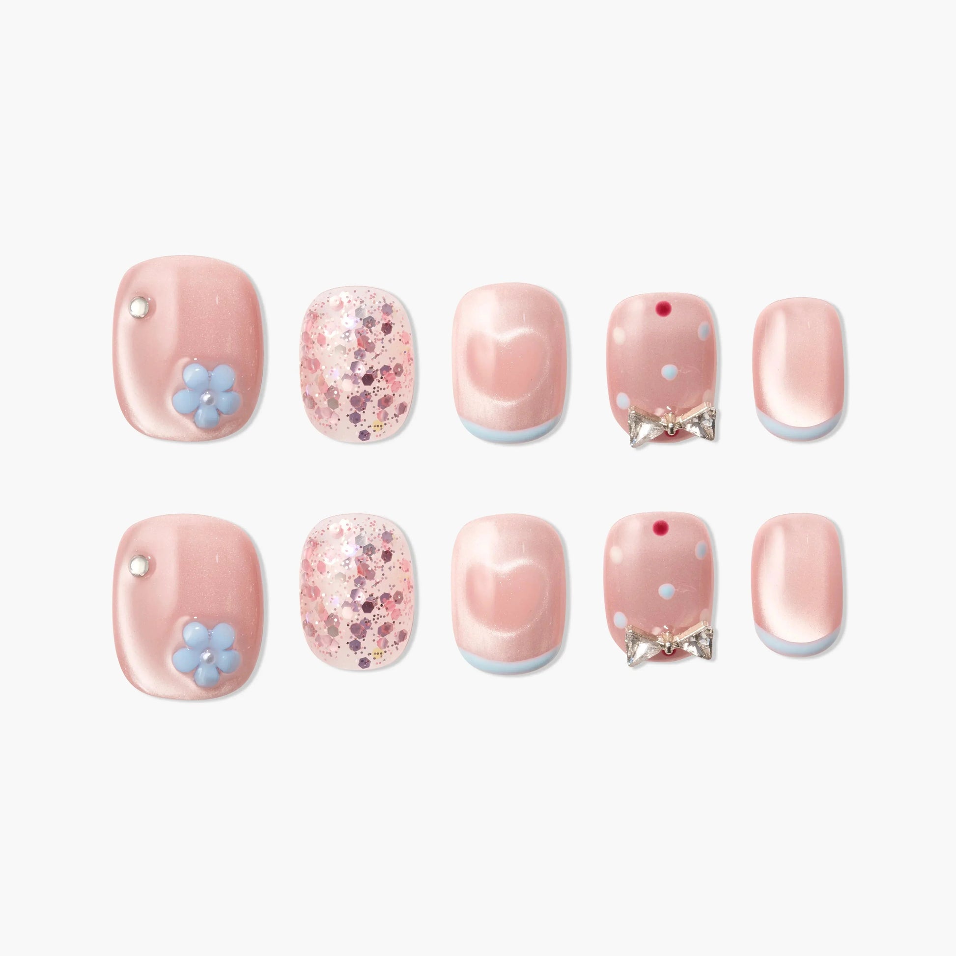 Pink press-on nails with floral accents, bows, glitter, and heart designs, displayed on white background.