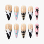 Handmade press-on nails with star, leopard, rhinestone, and pastel designs on a white background