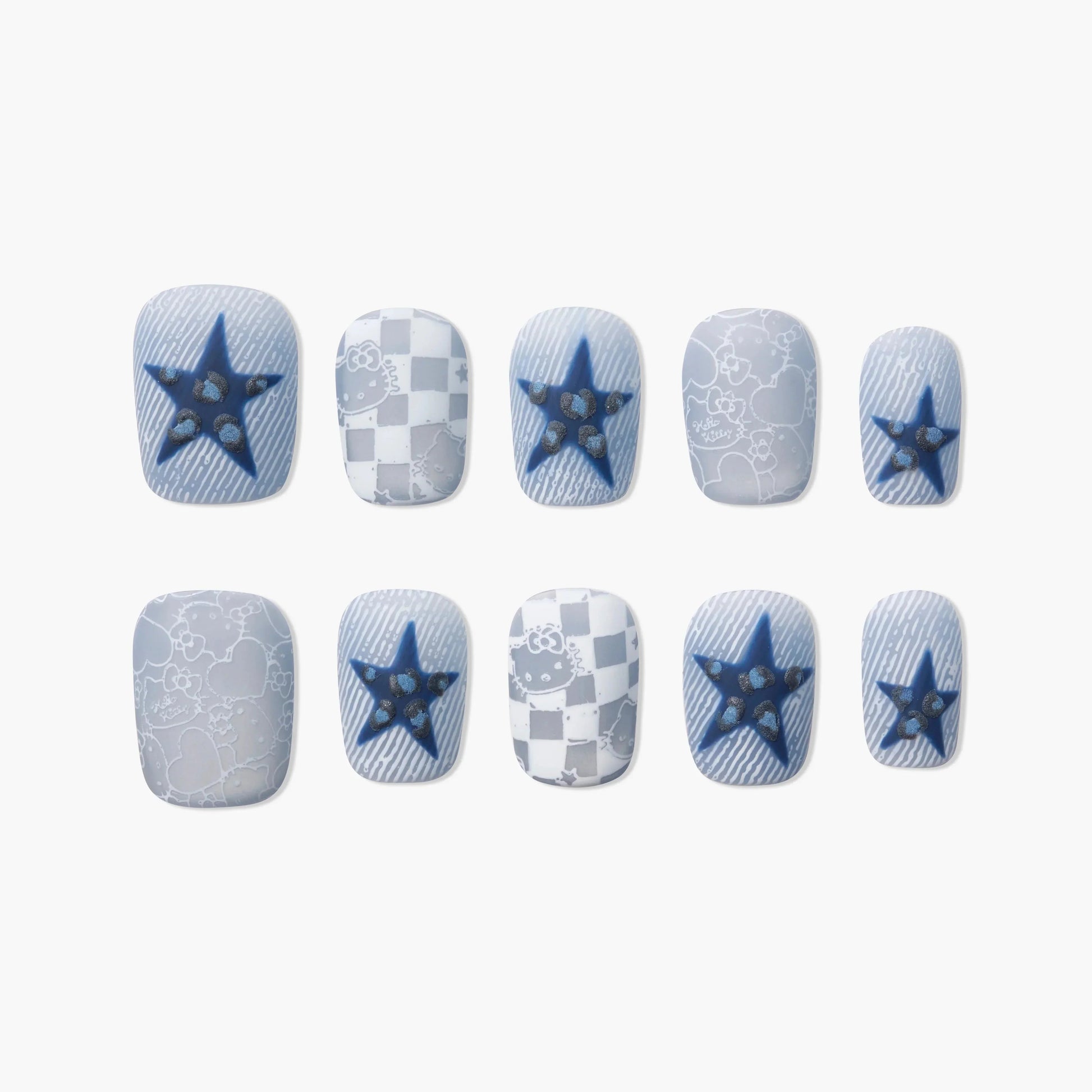 Handmade press-on nails with blue star, checkered, and cartoon heart designs on a white background