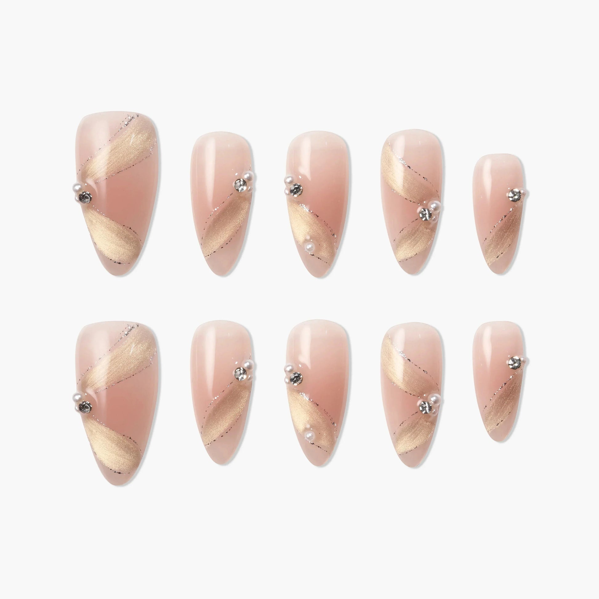 Almond-shaped press-on nails in pink with gold diagonal accents and pearl rhinestone details.
