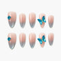 Handmade press-on nails with pink to blue ombre and 3D blue butterfly accents