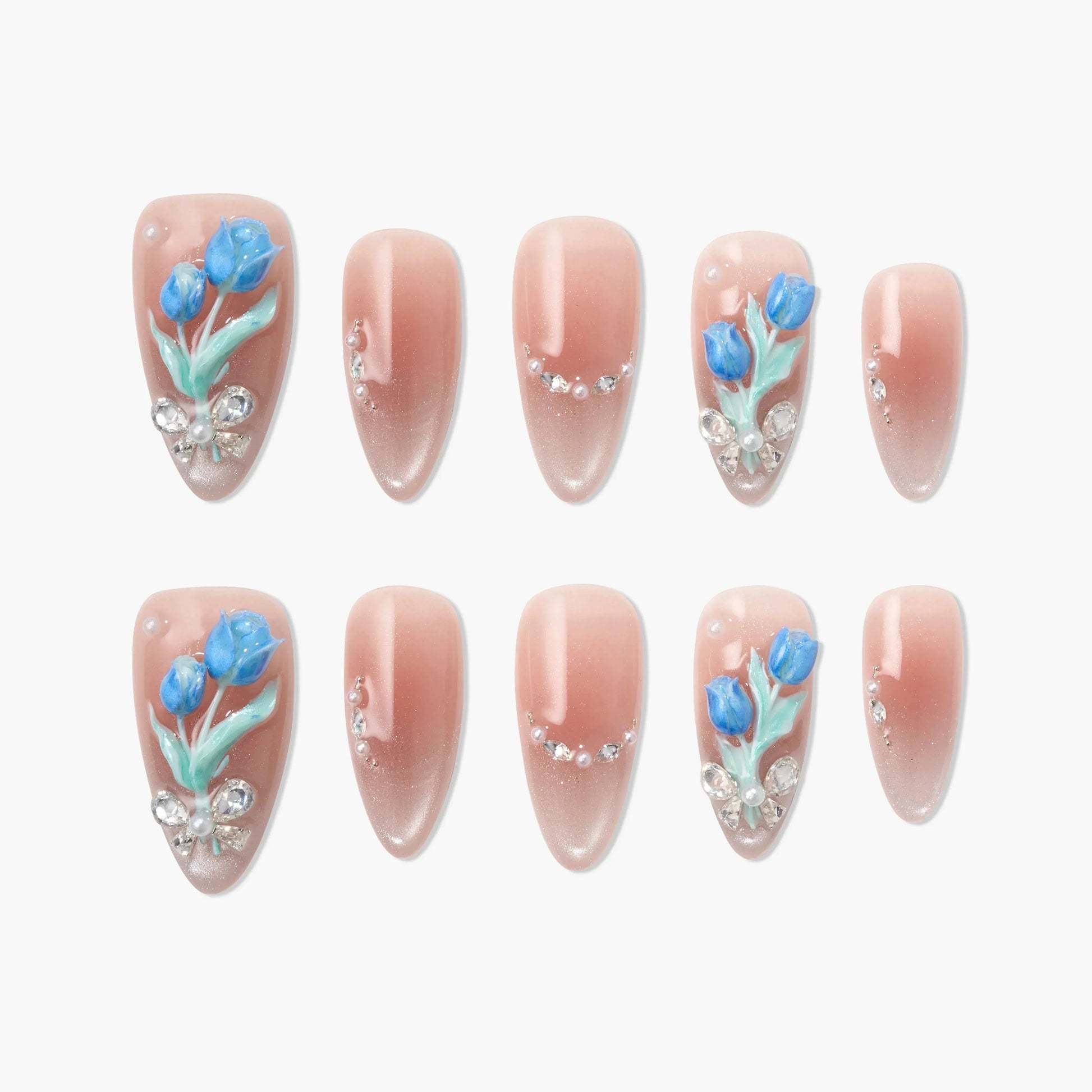 Nude almond press-on nails with blue floral 3D accents and rhinestone details