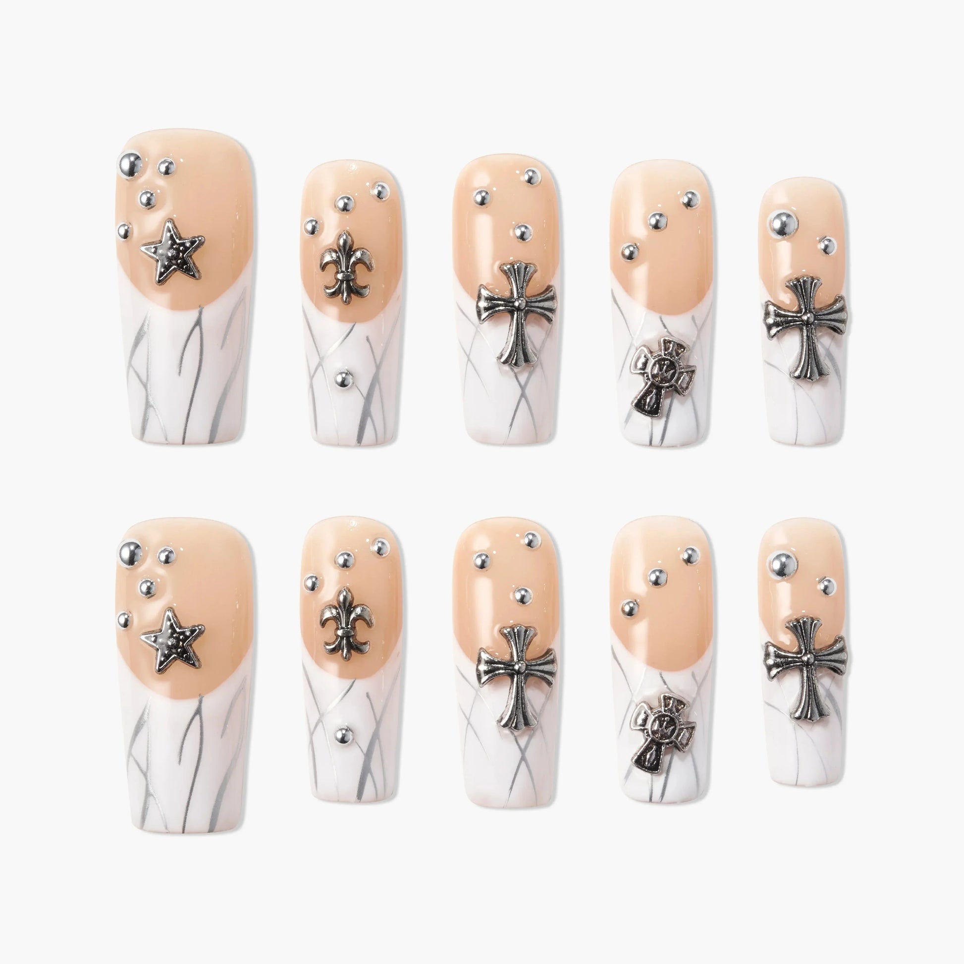 Handmade press-on nails with nude and white marble design, silver 3D star and cross charms, and rhinestone accents.