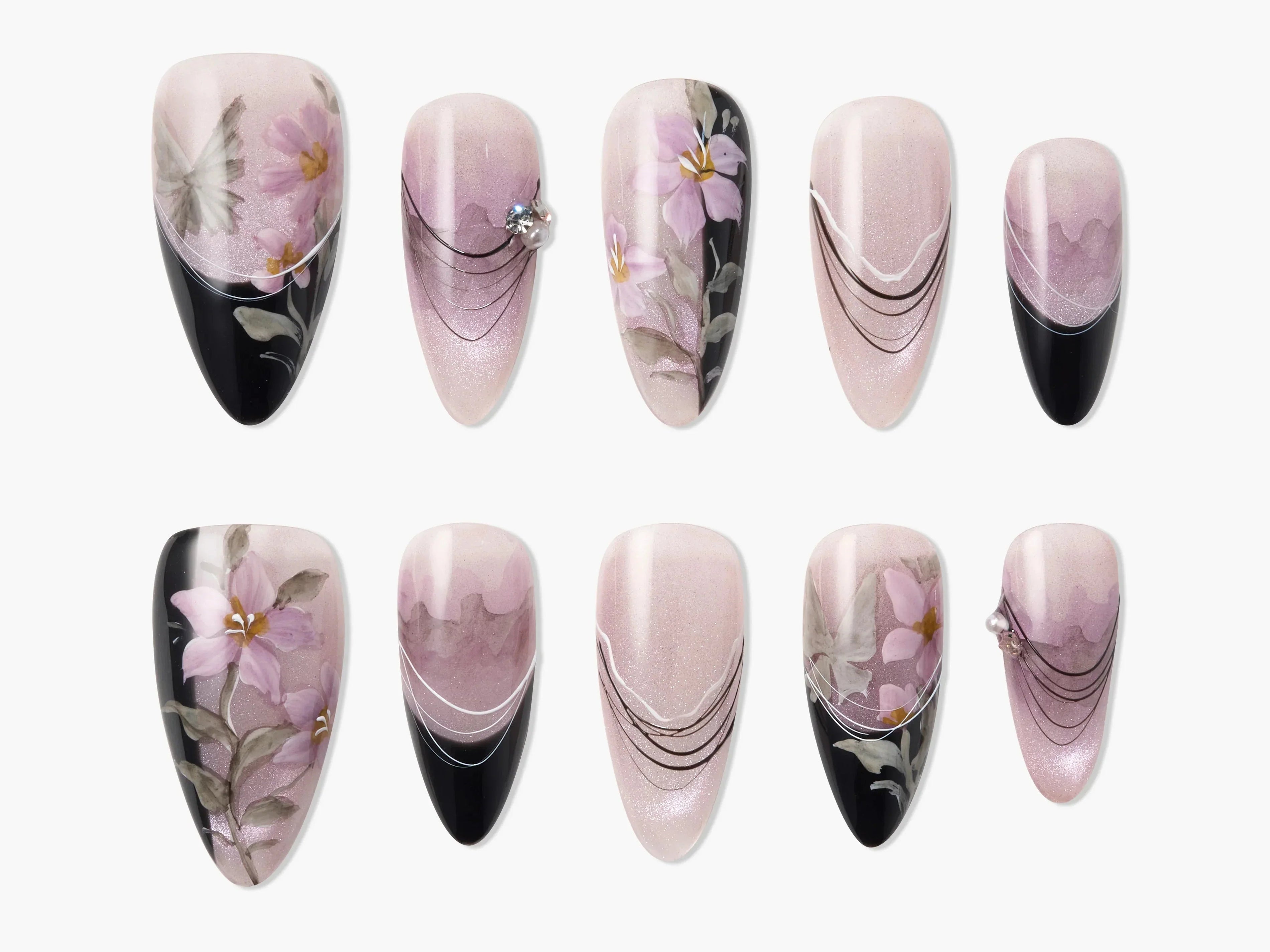 Handmade press-on nails with pink floral designs, black tips, and rhinestone accents