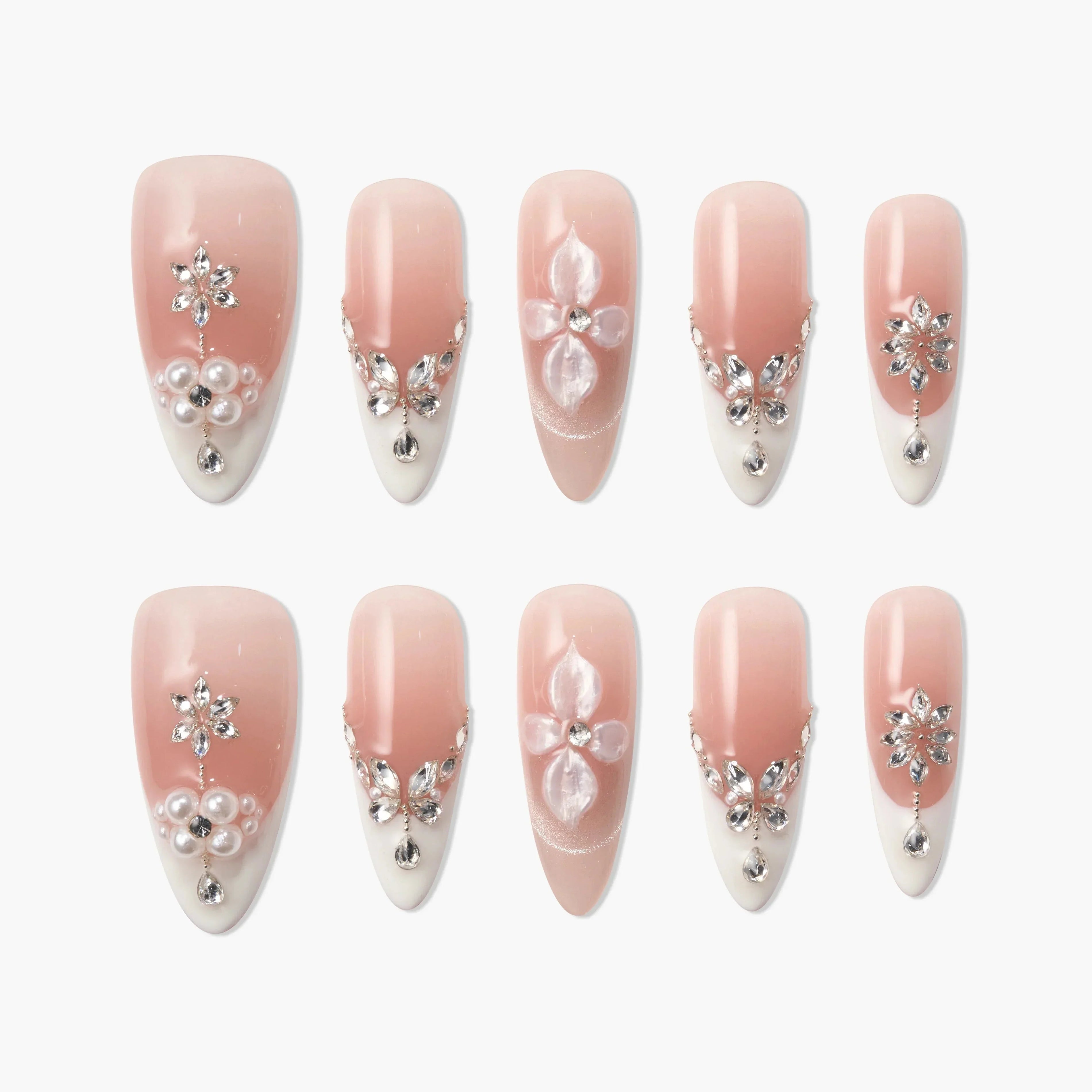 Handmade pink and white press-on nails with 3D floral designs, pearls, and rhinestones
