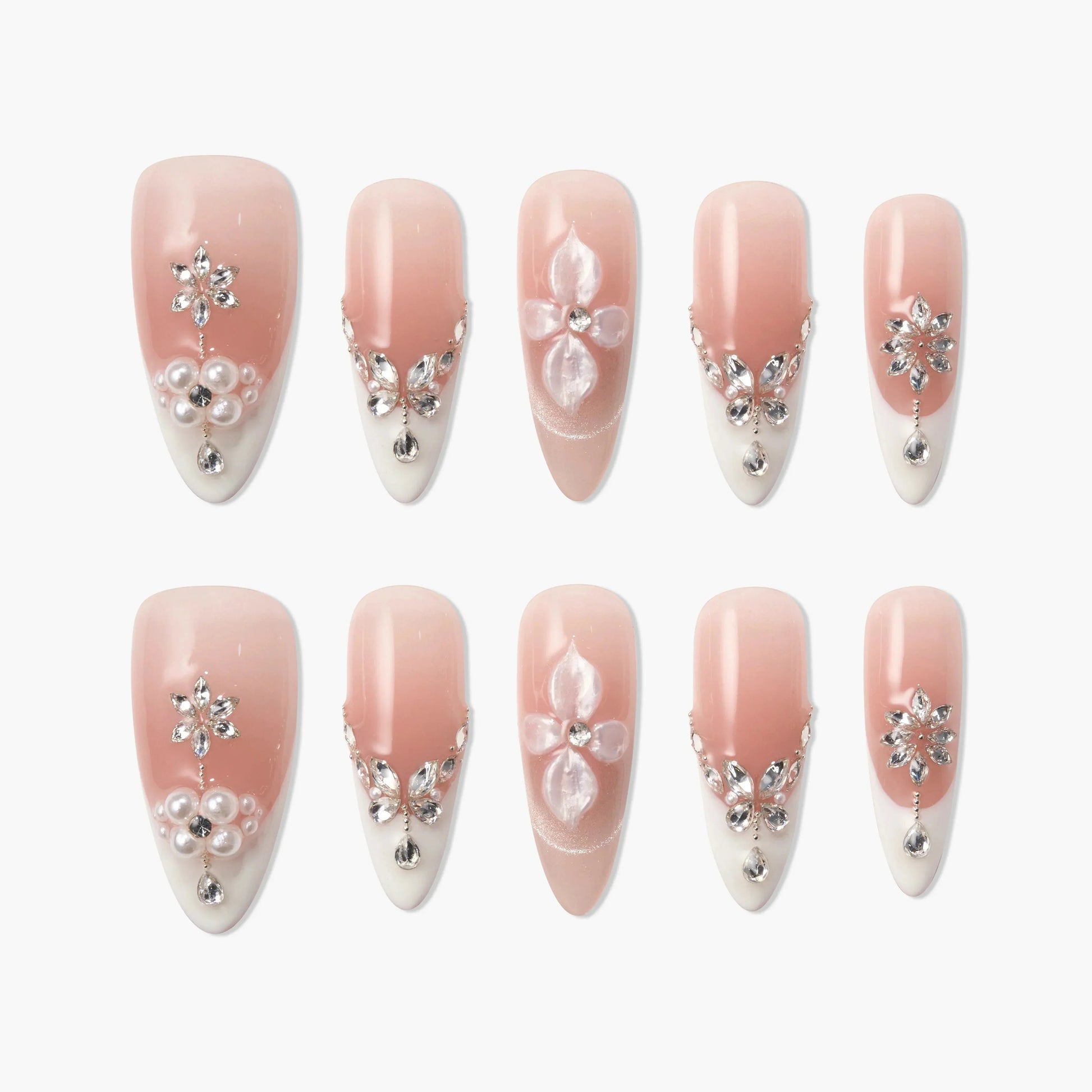 Handmade pink and white press-on nails with 3D floral designs, pearls, and rhinestones