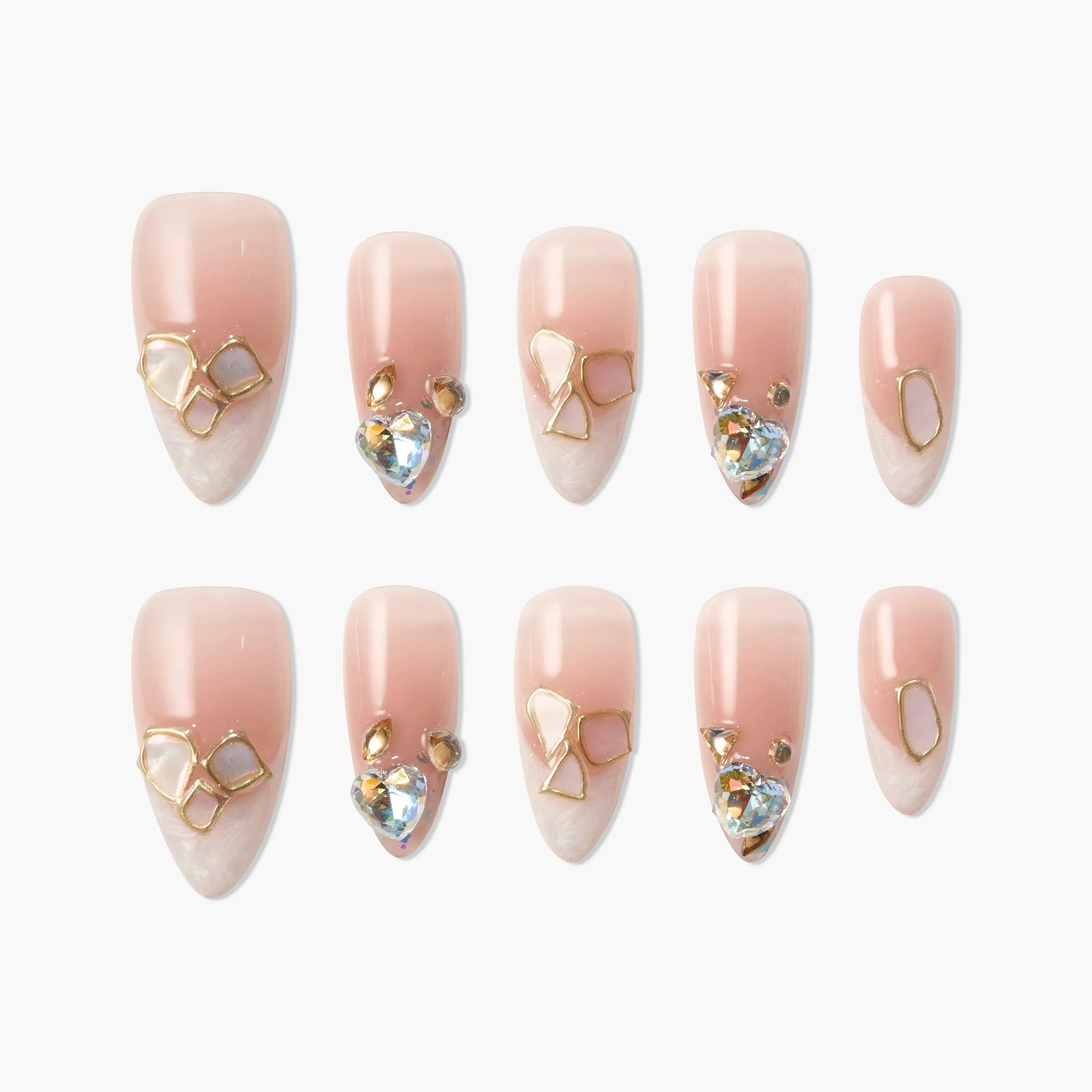 Set of pink ombre press-on nails with gold geometric accents and crystal gems
